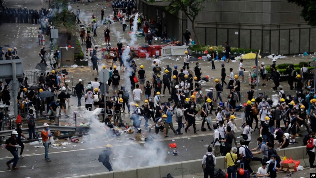 Riot police fire tear gas to protesters outside the Legislative Council in Hong Kong, June 12, 2019. 