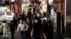 Personas con máscaras protectoras, en medio del brote de la enfermedad por coronavirus, se dirigen a un distrito comercial en Tokio, Japón, el 28 de julio, 2021.