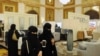 FILE - Saudi women wear the mandatory abaya, or loose-fitting gown, over their clothes in Jeddah, Saudi Arabia, Nov. 8, 2017. Rumors are circulating that a mixed-gender nightclub that does not require women to wear loose robes has opened in the city.