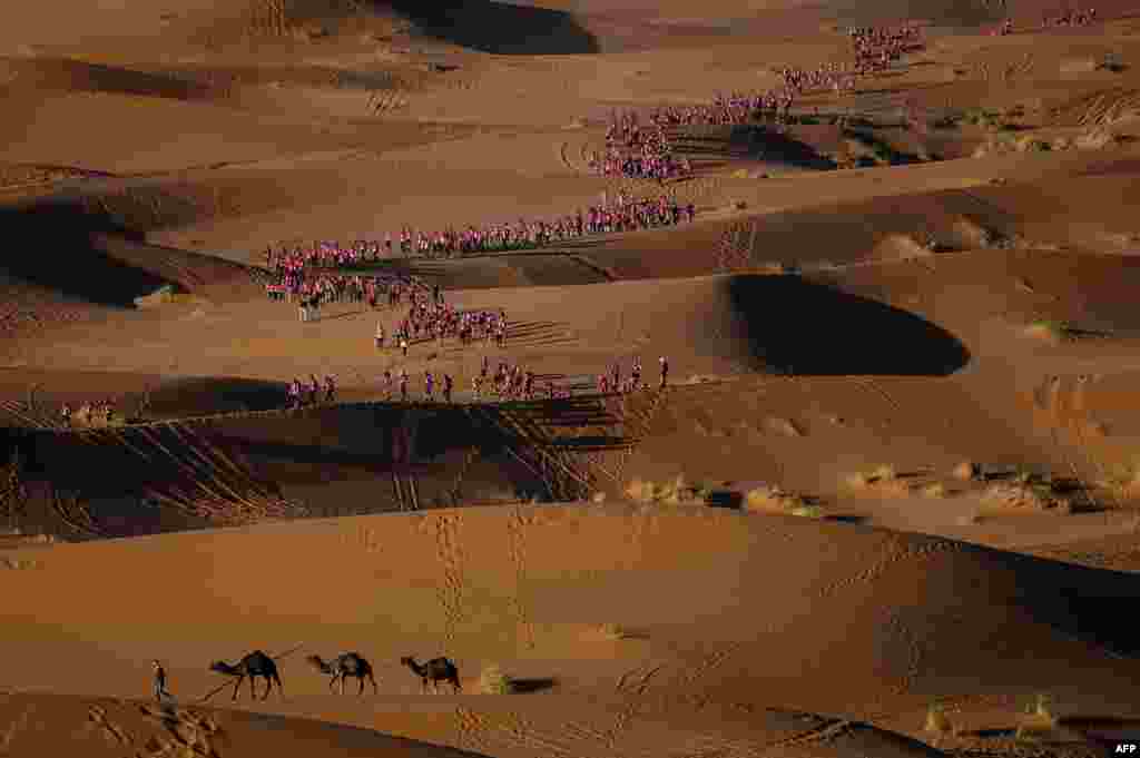 Women take part in the desert trek "Rose Trip Maroc" in the erg Chebbi near Merzouga. The Rose Trip Maroc is a female-oriented trek where teams of three must travel through the southern Moroccan Sahara desert with a compass, a map and a topographical reporter.