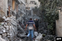 Palestinians check the rubble of a building after Israel's bombardment of the Al-Daraj neighborhood in Gaza City on April 16, 2024, amid ongoing battles between Israel and the Palestinian Hamas movement. (AFP)