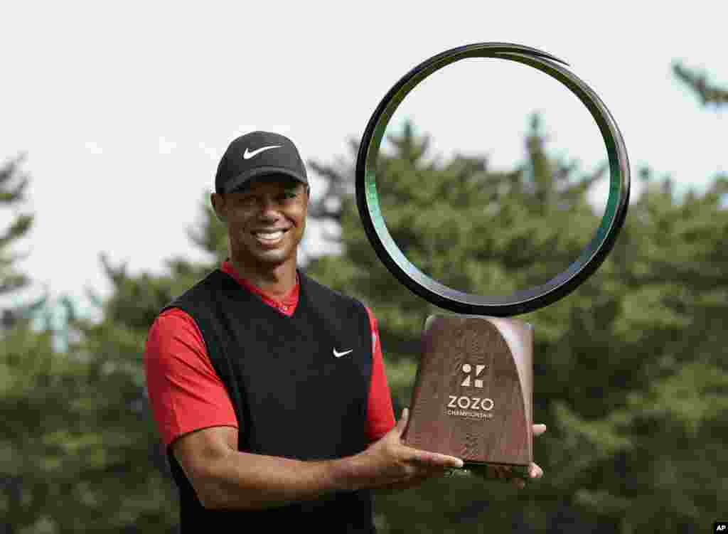 Tiger Woods of the United States poses with his trophy after winning the Zozo Championship PGA Tour at the Accordia Golf Narashino country club in Inzai, east of Tokyo, Japan.