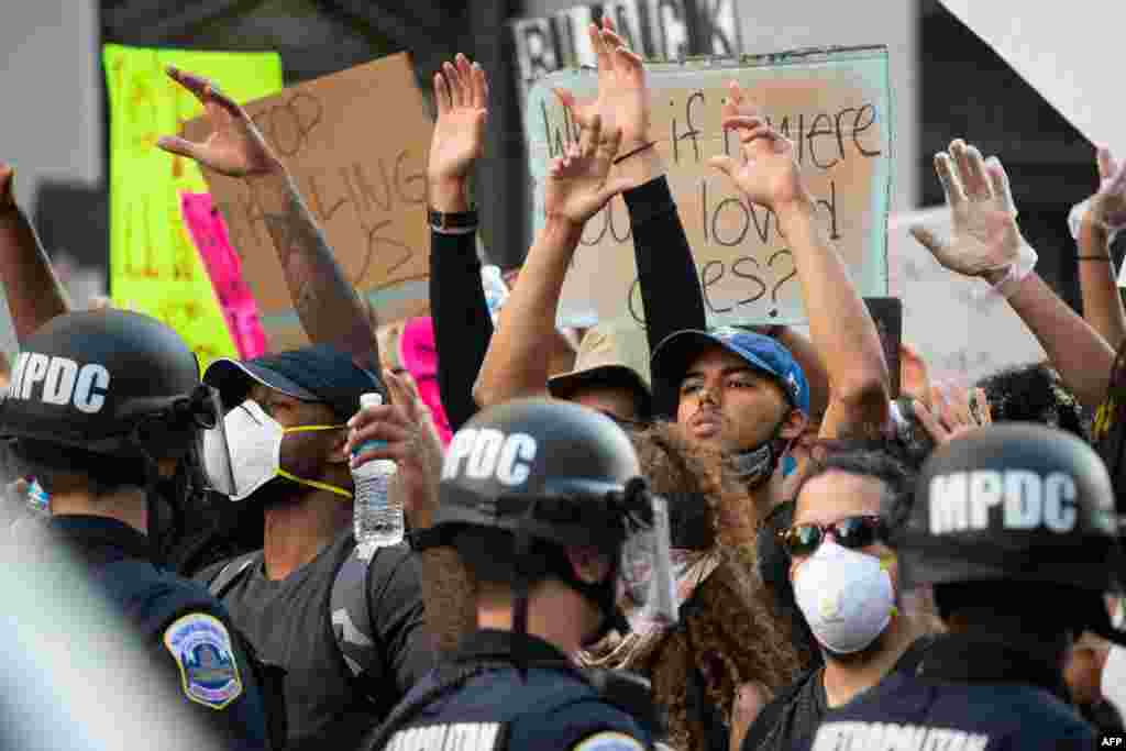 Protestors face a line of policemen to protest the death of George Floyd next to the White House on May 31, 2020, in Washington, D.C.