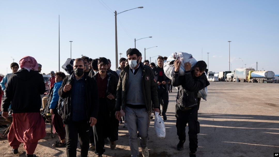 Deported Afghan migrants enter Afghanistan from Iran at the Islam Qala border crossing, Wednesday, Nov. 24, 2021. 