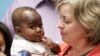 Foster mom Nancy Swabb holds Dominique, a 10-month-old baby born with two spines and an extra set of legs protruding from her neck during a news conference, March 21, 2017, at Advocate Children's Hospital in Park Ridge, Ill. 