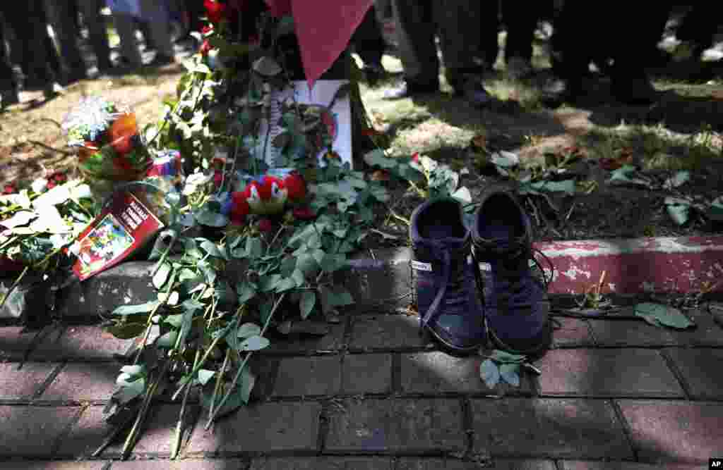 A pair of shoes belonging to a victim are seen next to flowers laid down by mourners at the site of Monday's explosion in the Turkish town of Suruc near the Syrian border, July 21, 2015.