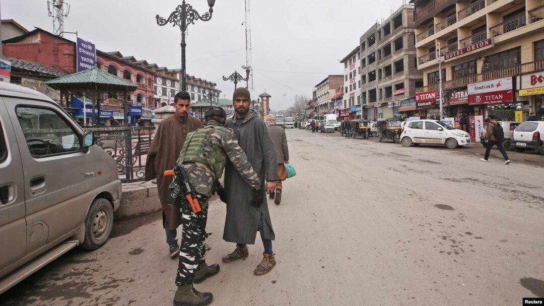 An Indian Central Reserve Police Force (CRPF) personnel frisks a man at a street in Srinagar, Feb. 18, 2019.
