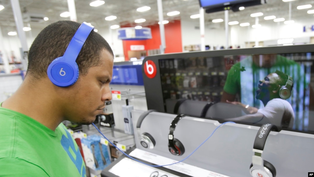 FILE - Eric Soriano listens to music with a pair of Beats headphones.