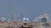 An Israeli military vehicle drives along the border with Gaza amid the ongoing conflict between Israel and the Palestinian Islamist group Hamas, as seen from southern Israel on December 20, 2023. (Clodagh Kilcoyne/Reuters)