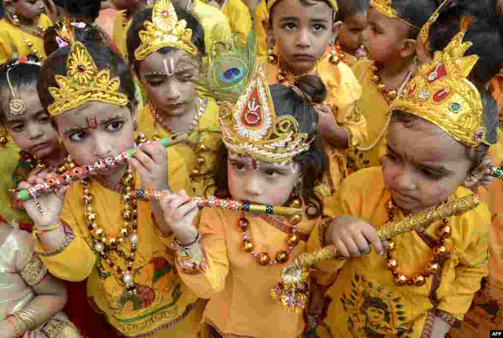 Schoolchildren dressed up as Hindu deity Krishna perform during celebrations on the eve of the Janmashtami festival that marks Krishna's birthday, in Amritsar.