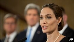 Angelina Jolie, in her role as U.N. envoy, talks during a news conference regarding sexual violence against women in conflict, during the G8 Foreign Ministers meeting in London, April, 11, 2013. 