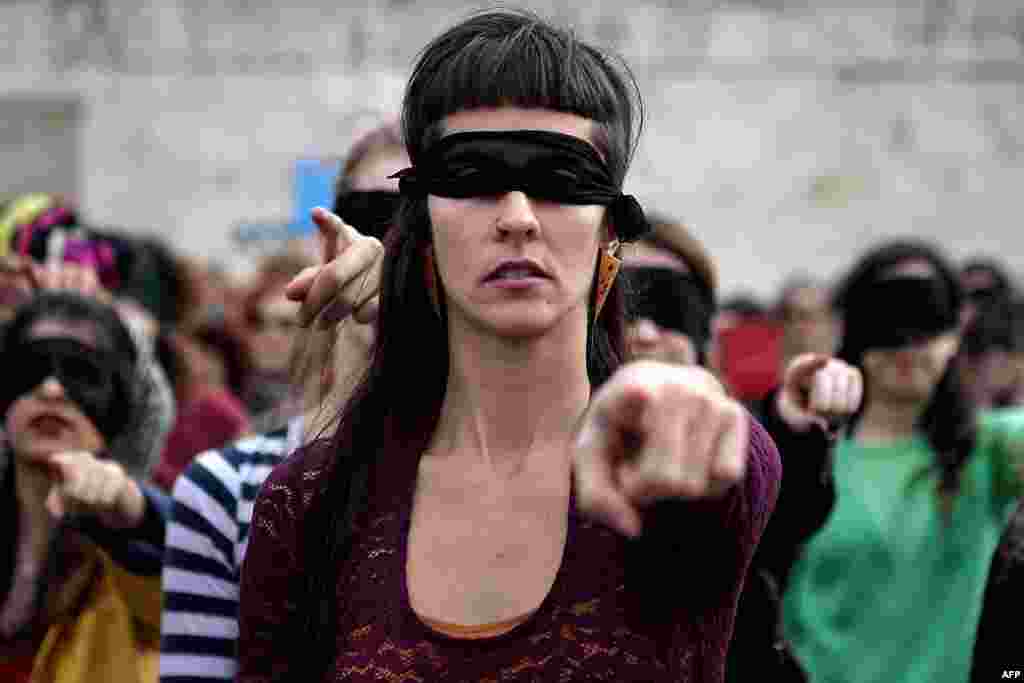 Female activists perform a choreography originated in Chile, and inspired by the Chilean feminist group Las Tesis, to protest against gender violence and patriarchy in front of the Greek parliament at Athens' Syntagma Square, Greece.
